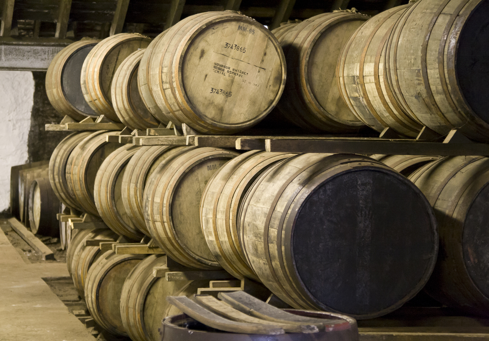 A racked warehouse of maturing oak casks.