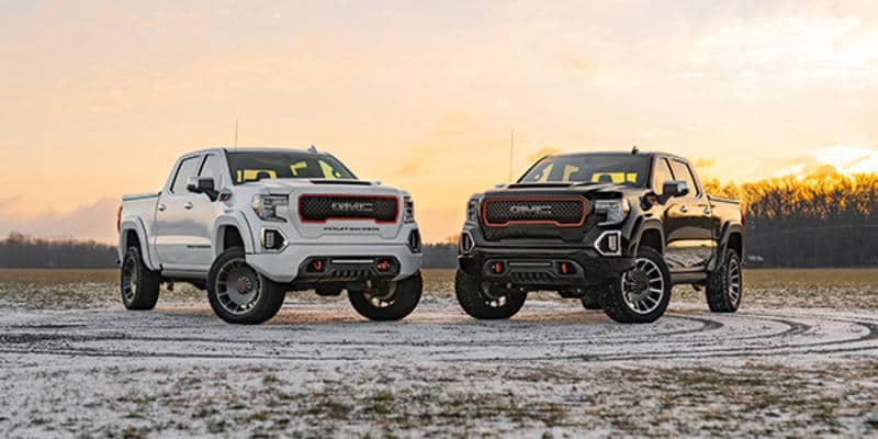 Two rugged 2020 Harley Davidson trucks parked on a misty and snowy rocky trail, ready for any off-road adventure