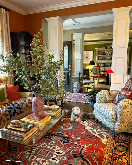 A layered and colorful traditional styled living room with an English influence