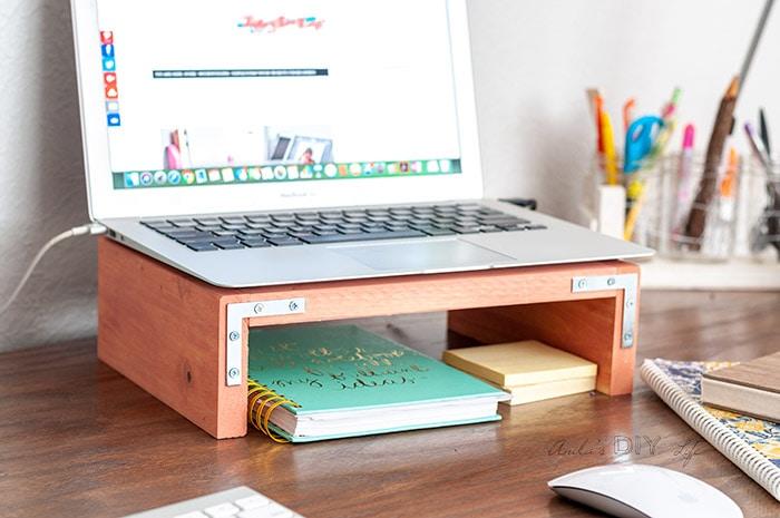 Laptop desk stand with post it notes and planner underneath
