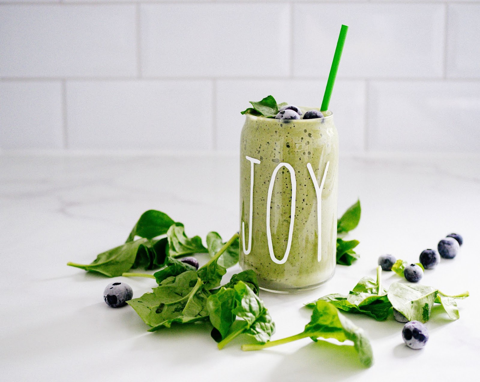 Green smoothie with "joy" written on glass