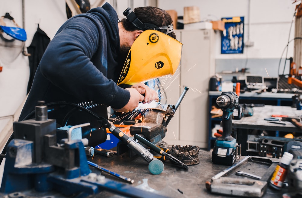 individual working on repairing a machine