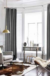 The velvet curtails hung around a large window. 