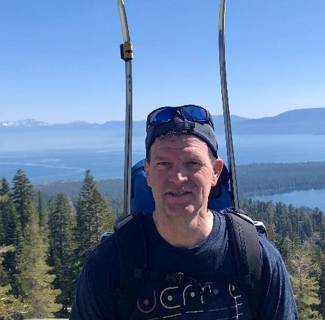 A picture containing sky, outdoor, person, tree Description automatically generated