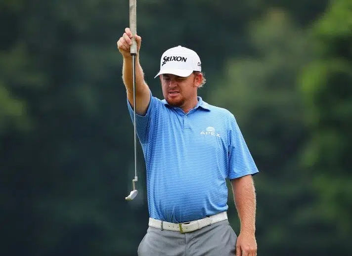 golfer holding up club to help putt