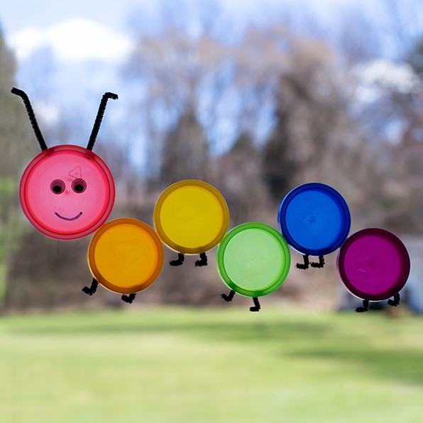 a caterpillar dreamcatcher made from plastic play-doh lids