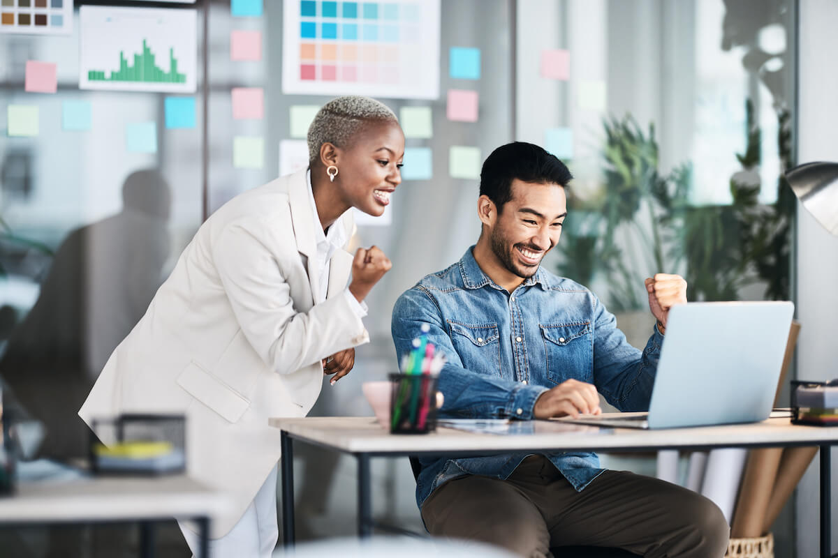 Tracking patients: excited employees looking at a laptop