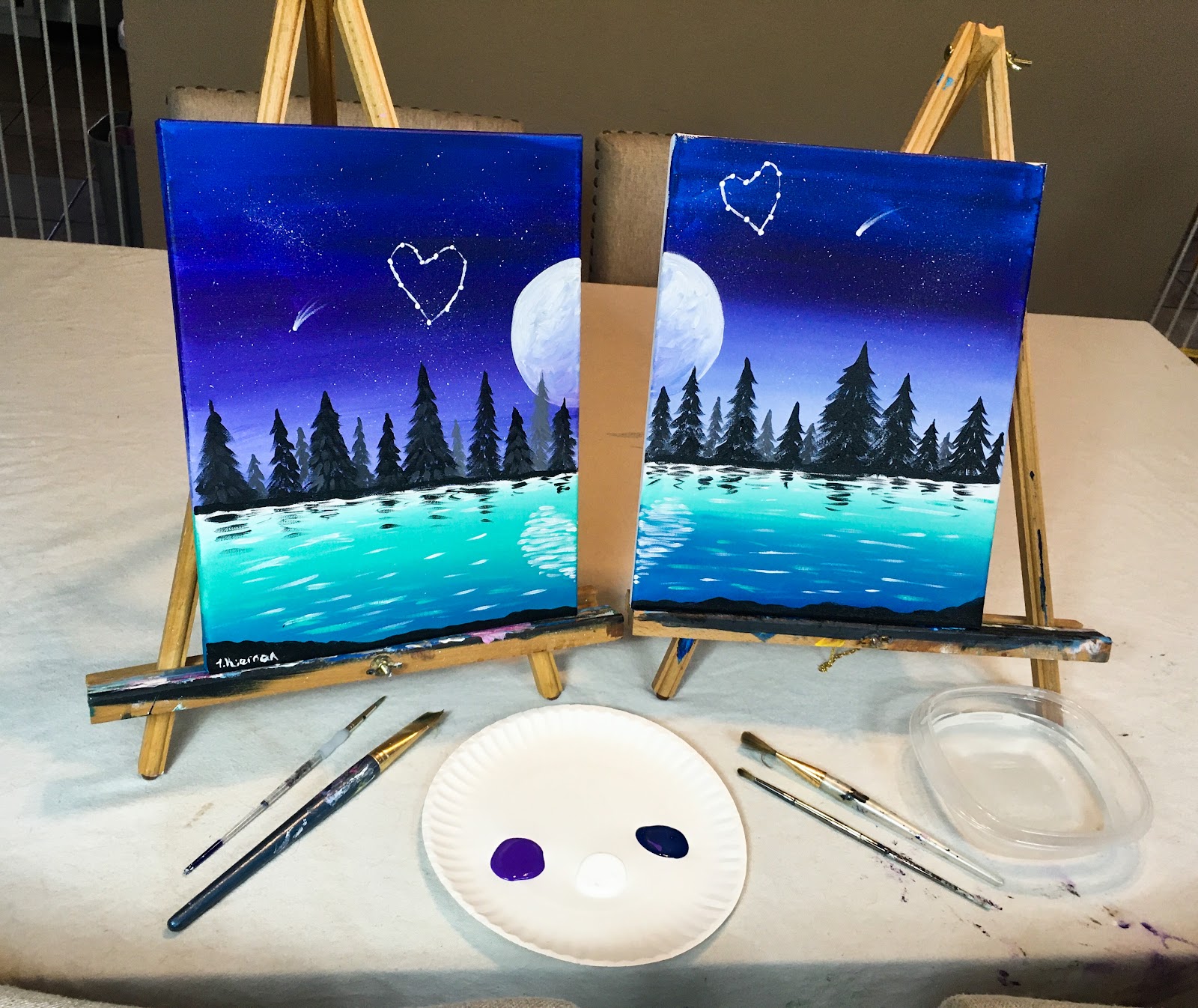 set up for couples date night at home paint night with painted canvases 