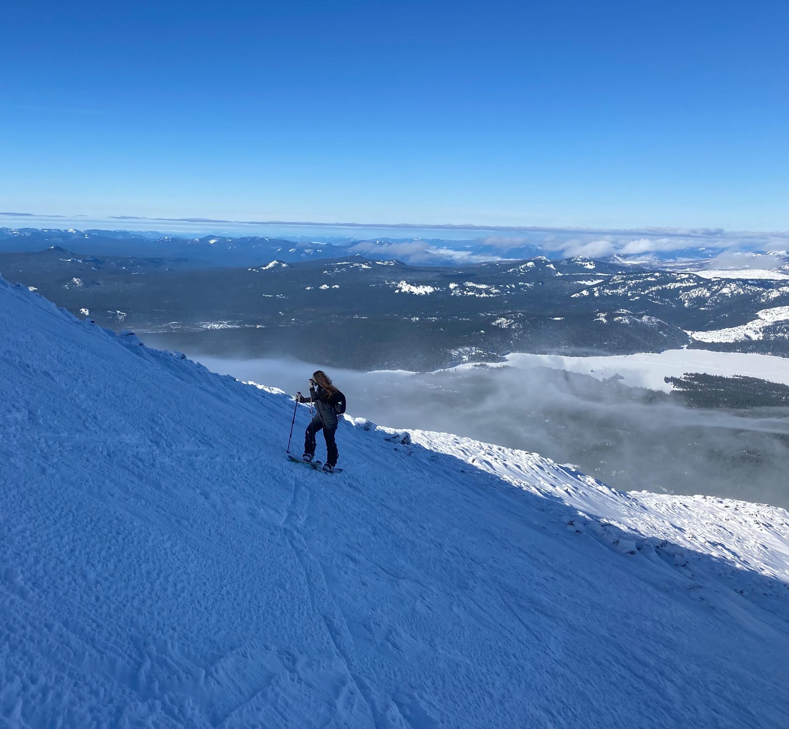 A couple of people skiing on a snowy mountainDescription automatically generated with low confidence