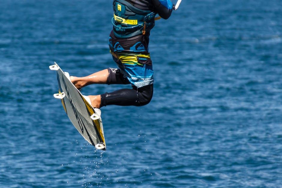 Person inwards Blue too Black Board Shorts on White Wake Board Tips for Your First Surf Holiday