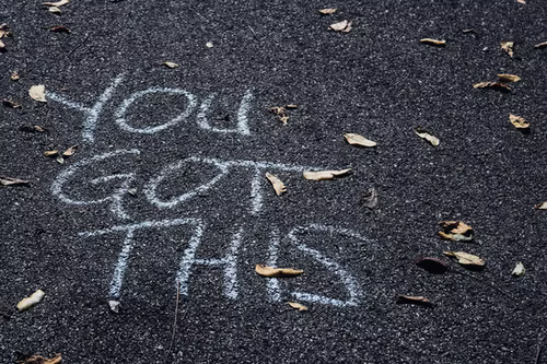 You Got This' written on the road with white chalk