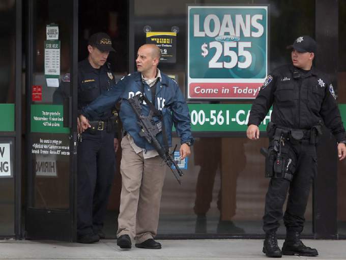 cop with asault rifle exiting crime scene.jpg