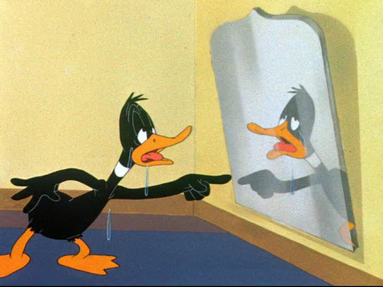 Daffy Duck pointing at himself in the mirror in "Draftee Daffy"