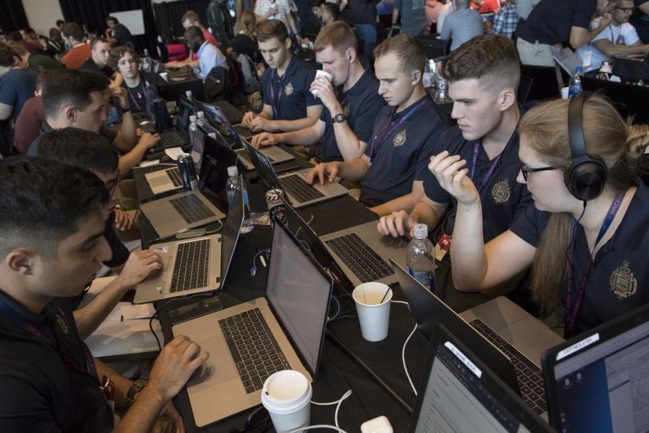 A team of Naval Midshipmen and Air Force Airmen from the Naval Academy and Air Force Academy participate in rack one during HacktheMachine competition at the Brooklyn Navy Yard in New York City in September 2019. Photo by Bryan lyankoff/U.S. Navy