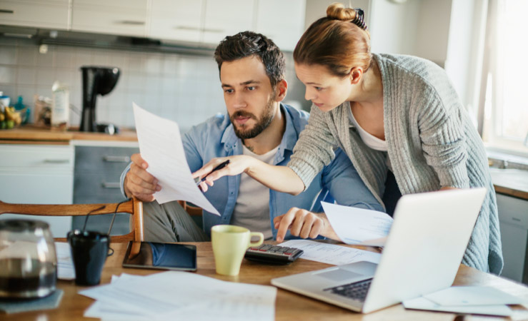 A couple looking through multiple offers on their house