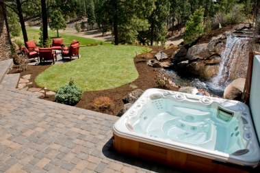 Lake Michigan backyard with waterfall hot tub dining area native plants