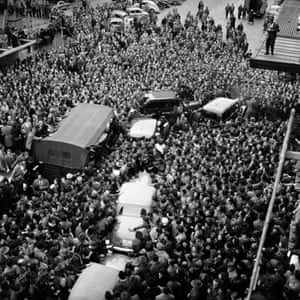 Original Caption: Hundreds of Germans, mostly teenagers, halt the car of Italian actress Gina Lollobrigida, centre, as she arrives in Stuttgart, Germany on 19 March 1957 for a personal appearance. Police escort cars, upper center, also were stopped by the mob. Gina, who arrived in the South German city after being named West Germanys most popular star, reached her hotel unscathed. Many persons in the crowd, however, suffered minor injuries or had their clothes torn