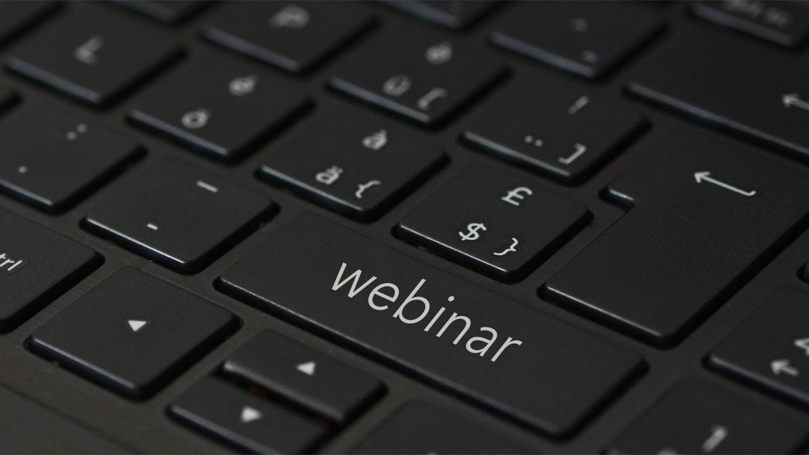 A closeup image of a keyboard where one of the keys says 'webinar'