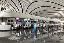 https://upload.wikimedia.org/wikipedia/commons/thumb/8/88/China_Eastern_Airlines_check-in_counters_G_at_ZBAD_%2820190823144421%29.jpg/220px-China_Eastern_Airlines_check-in_counters_G_at_ZBAD_%2820190823144421%29.jpg