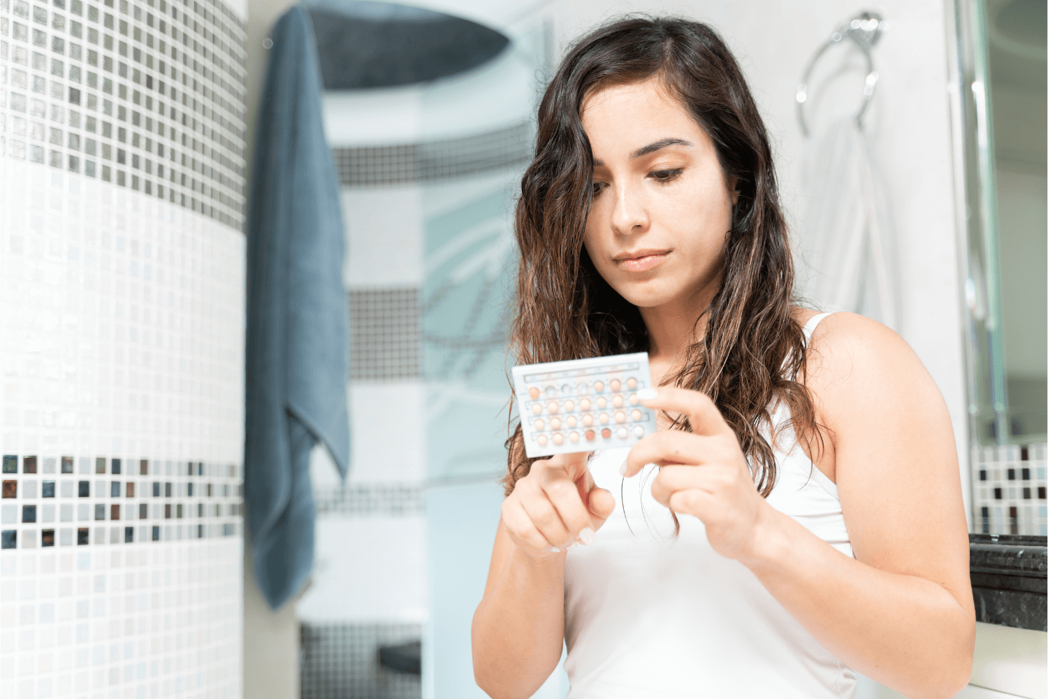 Woman holding a pack of birth control pills