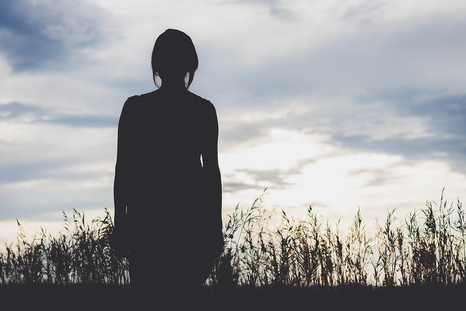 silhouette of woman in a field