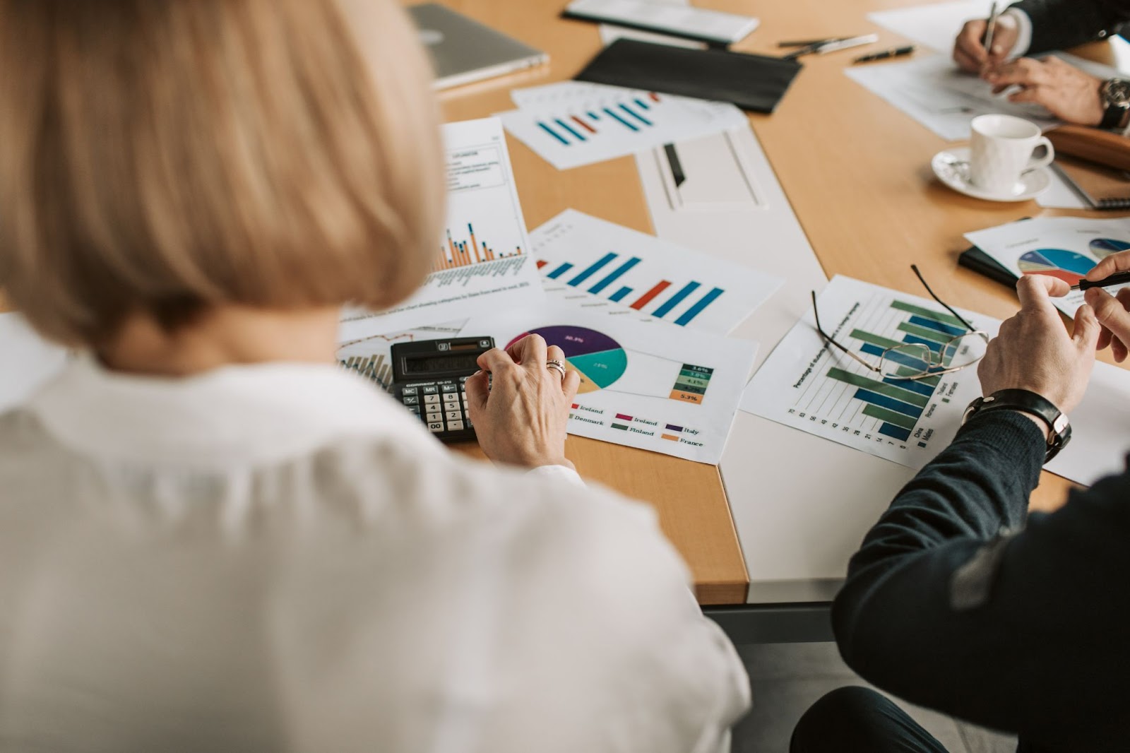 bookkeepers sitting together with financial reports and calculators 