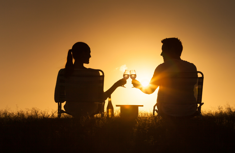 couple enjoying a glass of wine at sunset