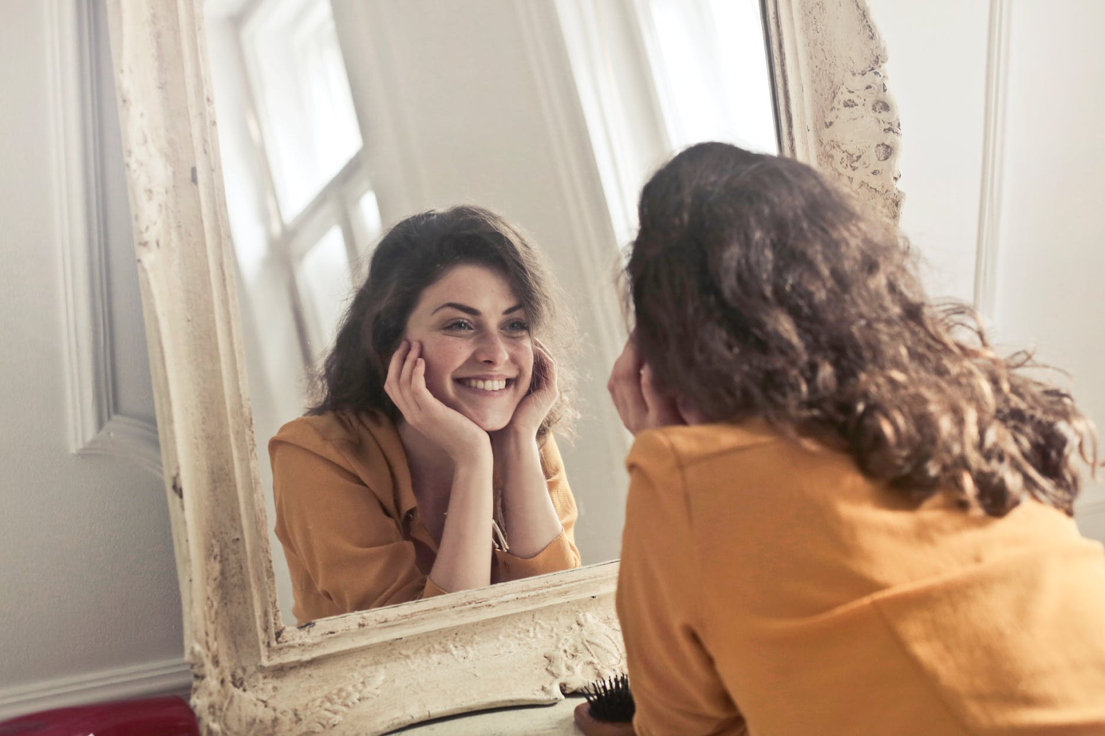woman posing in mirror feeling good