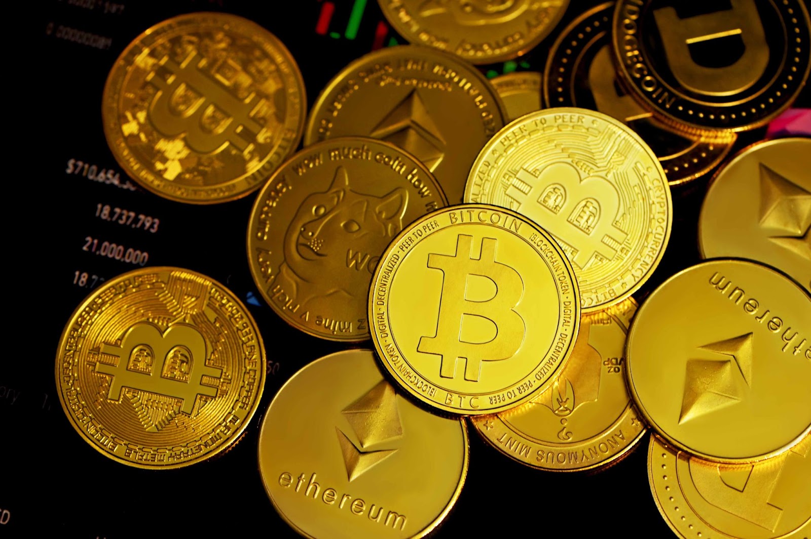 Image of gold coins with cryptocurrency logos. 