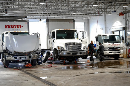 Hino delivery trucks being serviced inside Somerville Hino's North York garage