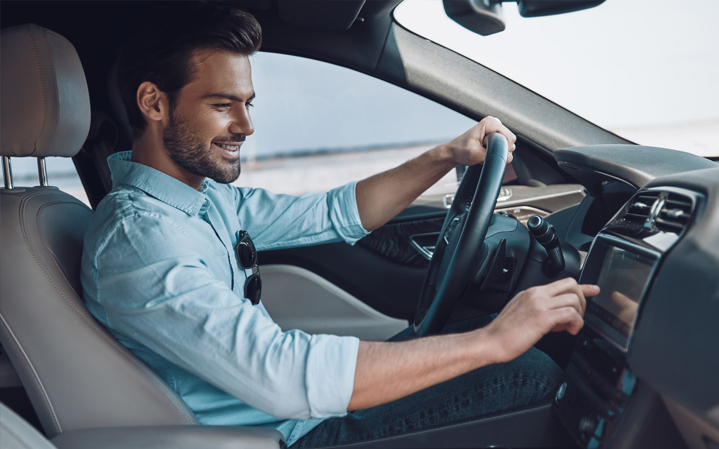 what is highway hypnosis? happy man listening to car music to avoid highway hypnosis