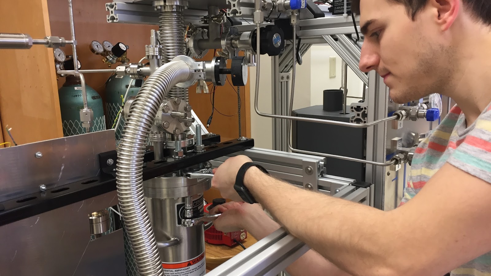 Nedlick sealing liquid xenon in the UMass model of the LZ detector that he and Scott Hertel built in Hertel’s lab. Image credit: UMass Amherst 