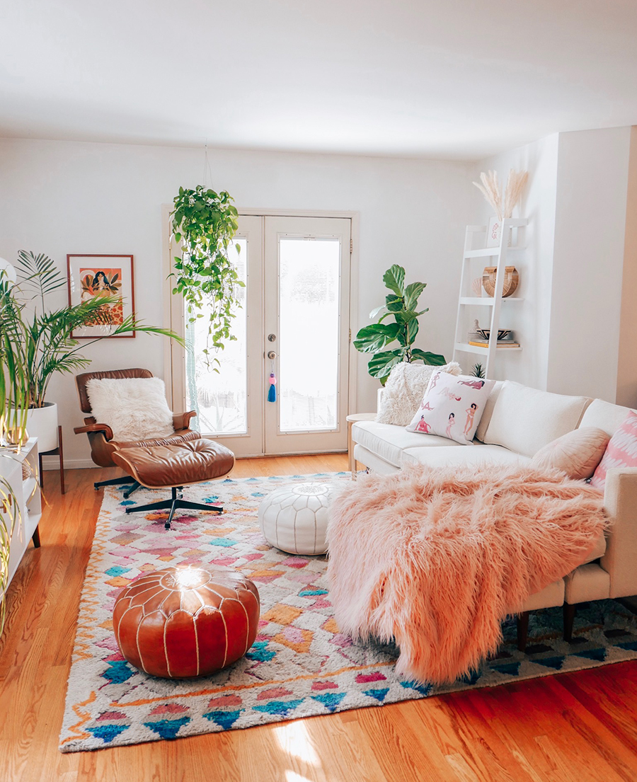 Modern Boho living room with white walls, a white sofa, and a Large colourful rug.