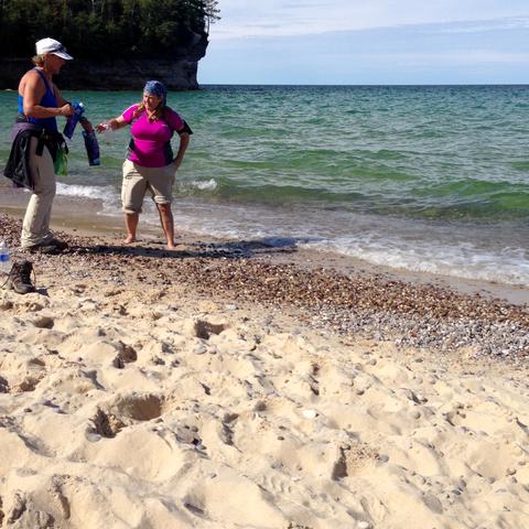 My companions showing me how to filter lake water for drinking water along the Pictured Rocks hiking route.