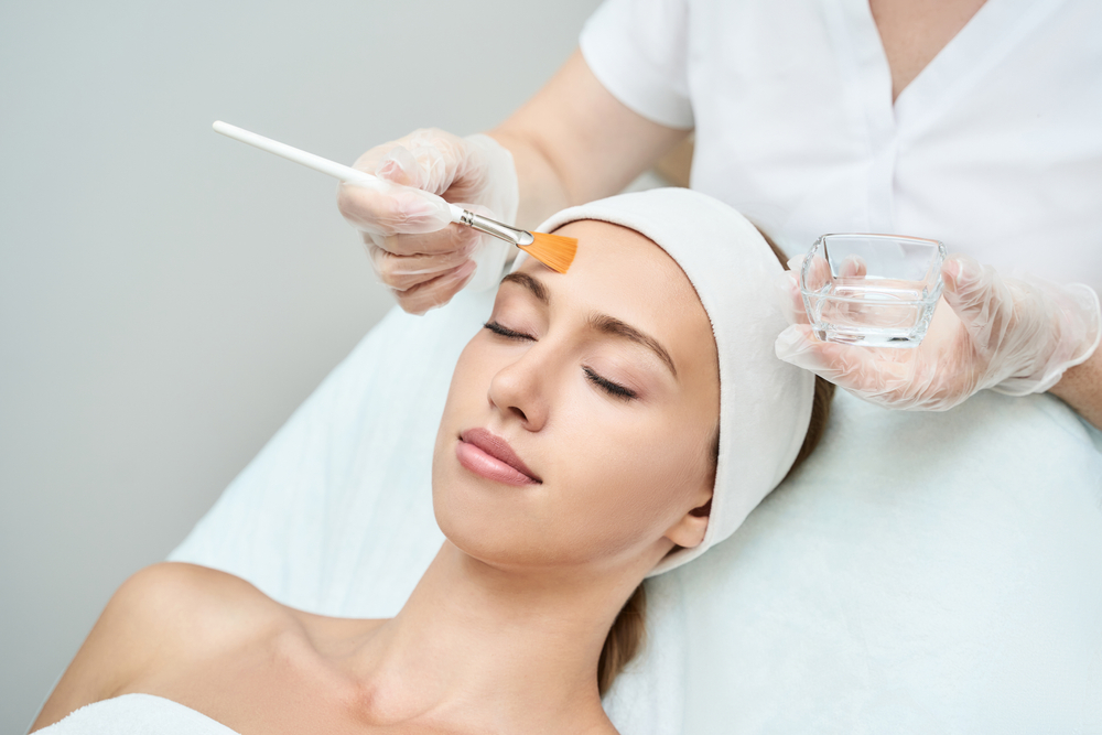 Young woman getting a chemical peel treatment.
