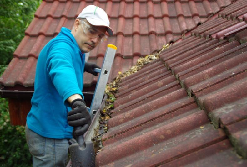 Person working on the gutters And roof