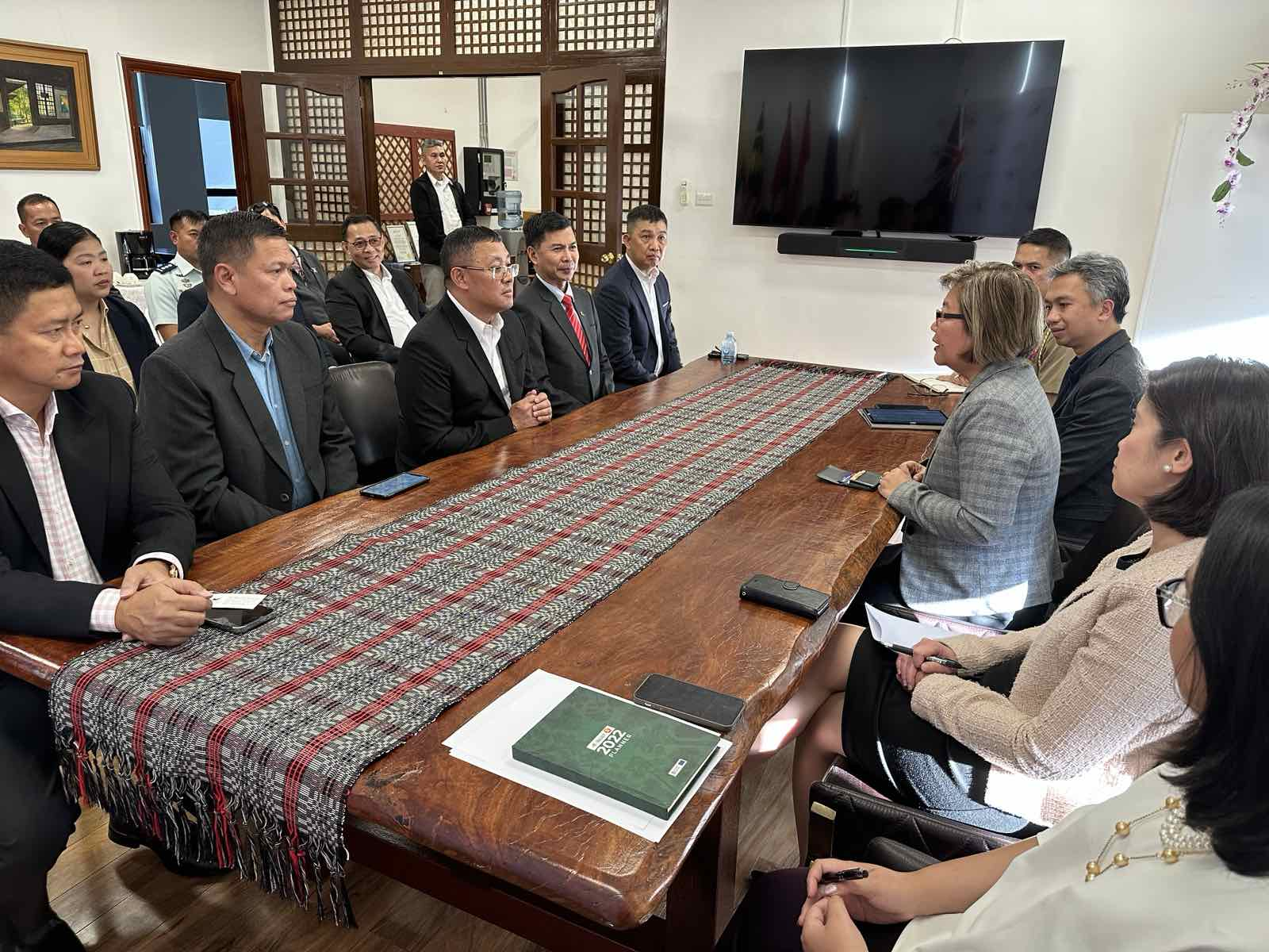 A group of people sitting around a tableDescription automatically generated