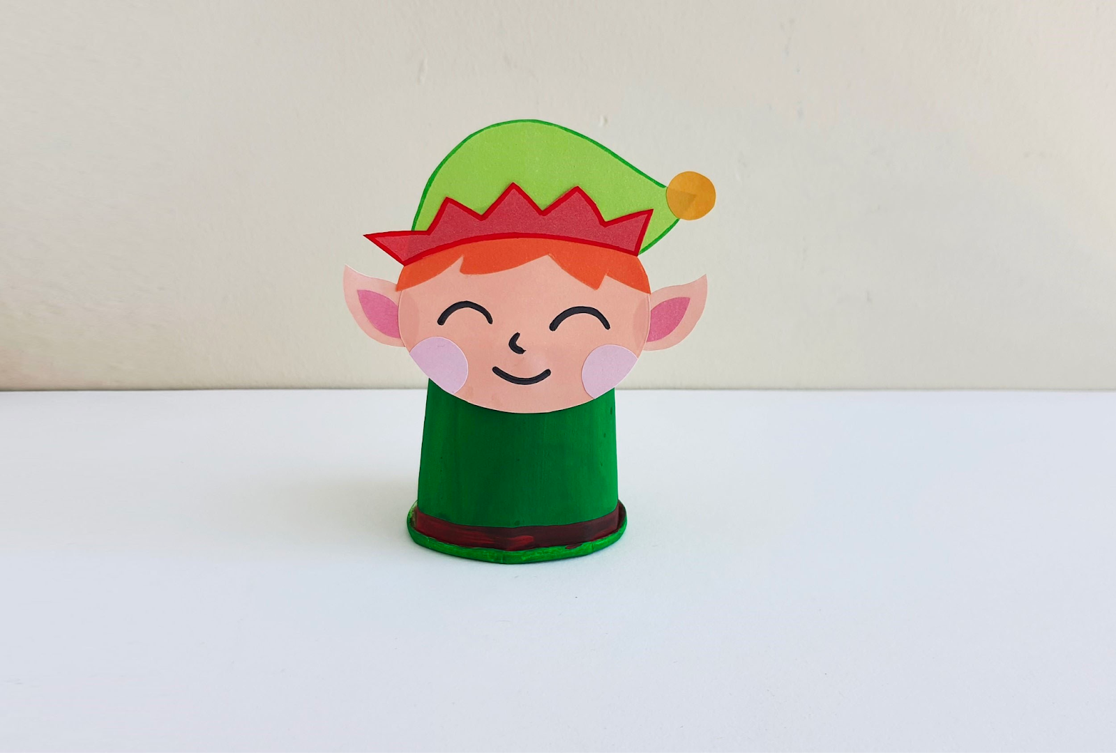 elf head attached to top of cup